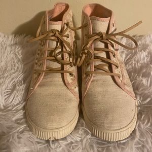 Blush pink tan and white hi top sneakers.